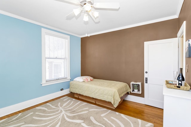 bedroom with wood-type flooring, crown molding, and ceiling fan