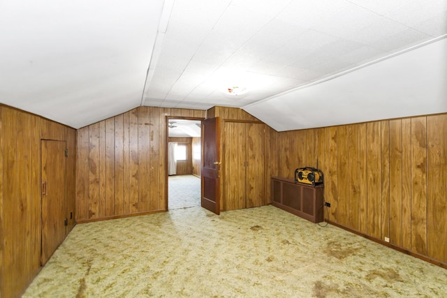 bonus room with vaulted ceiling and light carpet