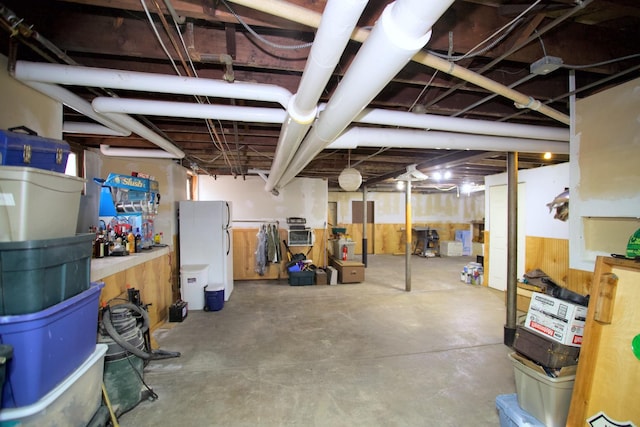 basement featuring white fridge