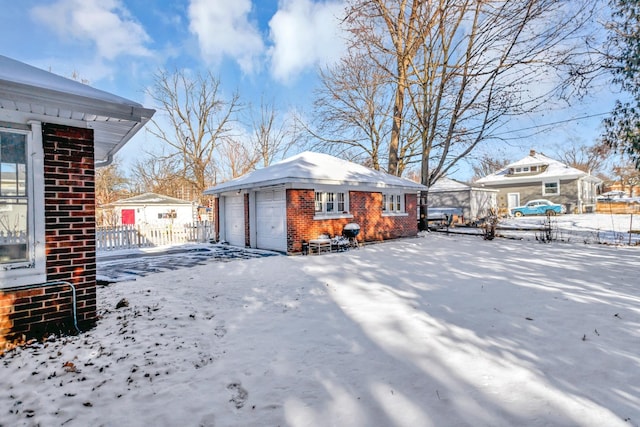 exterior space featuring a garage and an outbuilding