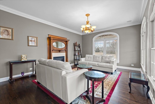 living room featuring crown molding, dark wood-type flooring, and an inviting chandelier