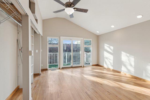 interior space featuring wood-type flooring, ceiling fan, and vaulted ceiling