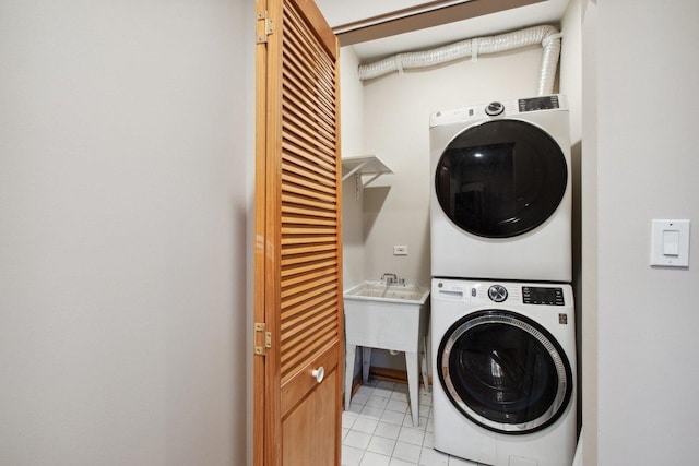 washroom with stacked washer / dryer and light tile patterned floors