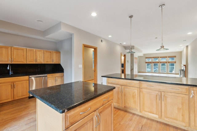 kitchen with dishwasher, sink, hanging light fixtures, a center island, and light hardwood / wood-style floors