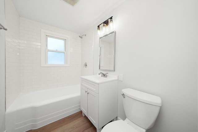 bathroom with toilet, bathtub / shower combination, wood finished floors, and vanity