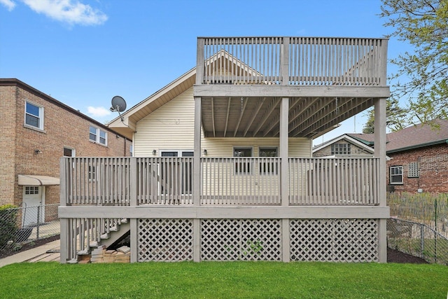rear view of house featuring a wooden deck and stairway