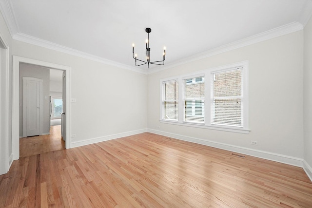 unfurnished room with a chandelier, ornamental molding, baseboards, and light wood-style flooring