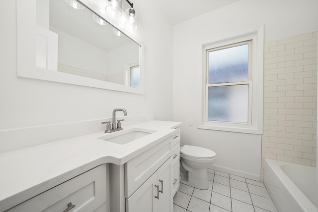 bathroom with toilet, vanity, tile patterned floors, and baseboards