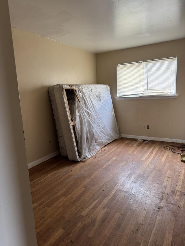 spare room featuring hardwood / wood-style flooring