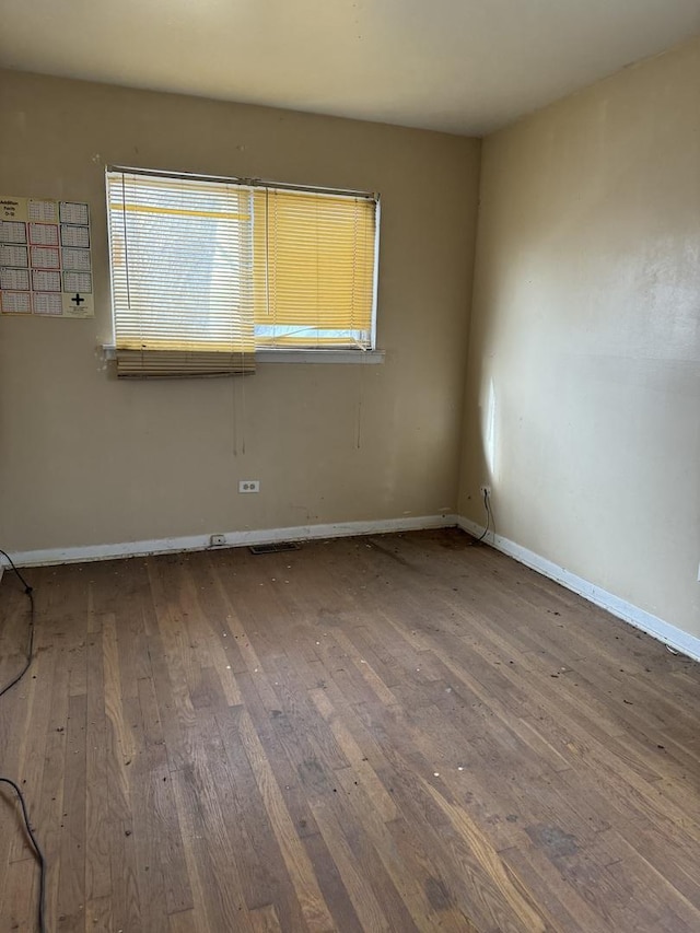 unfurnished room with wood-type flooring