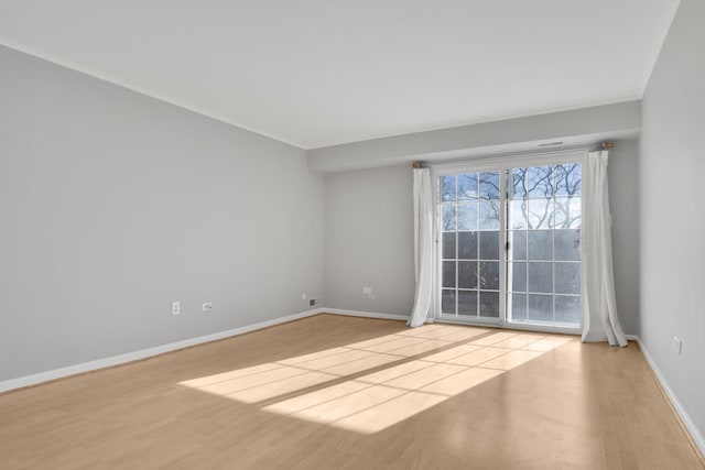 spare room featuring light hardwood / wood-style floors