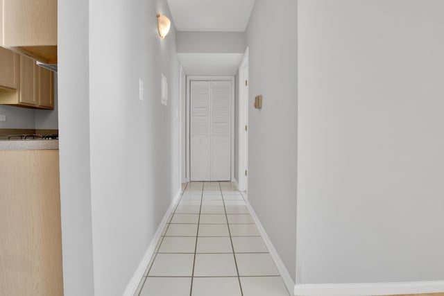 hall with light tile patterned floors