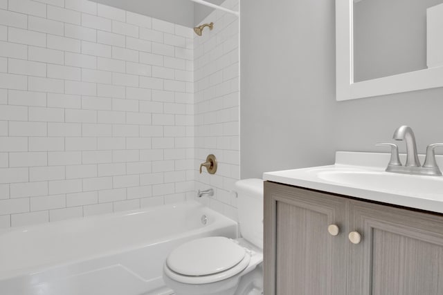 full bathroom featuring tiled shower / bath combo, toilet, and vanity