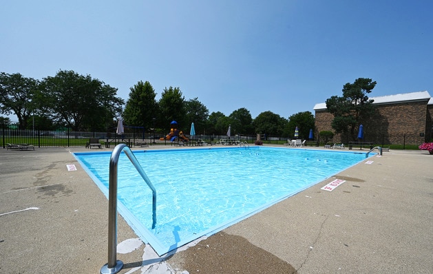 view of swimming pool featuring a playground