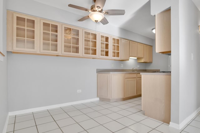 kitchen featuring sink, ceiling fan, light brown cabinetry, and light tile patterned floors