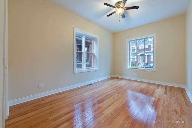 spare room with light hardwood / wood-style flooring and ceiling fan