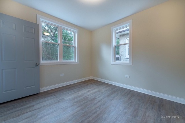 unfurnished room with dark hardwood / wood-style flooring