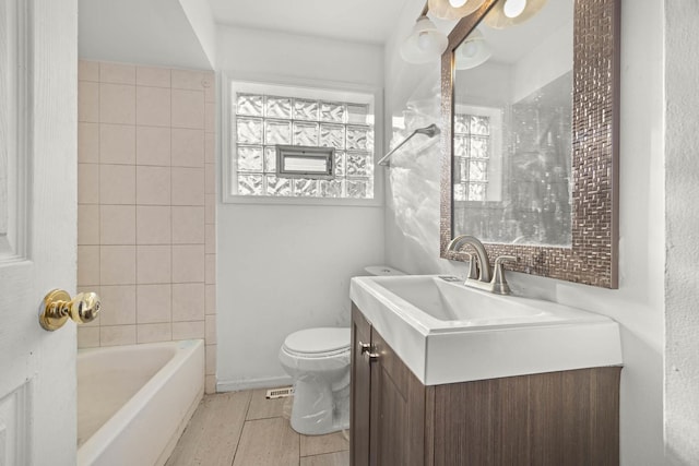 bathroom featuring toilet, vanity, and tile patterned flooring