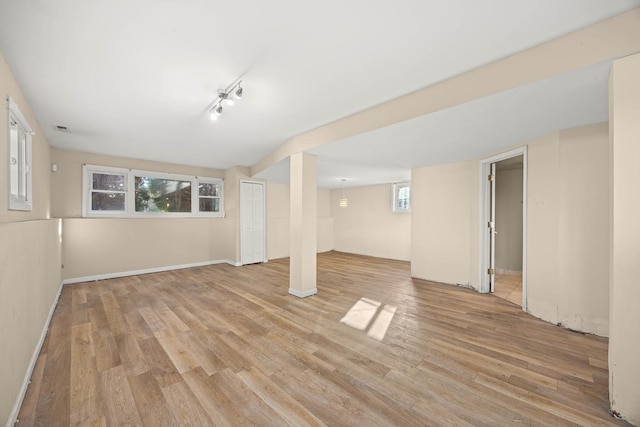 basement with light hardwood / wood-style flooring