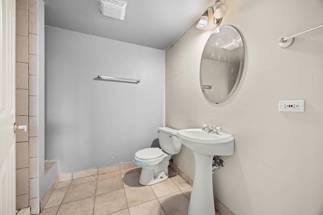 bathroom featuring toilet and tile patterned floors