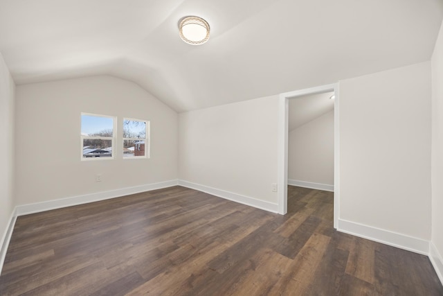 bonus room with lofted ceiling and dark hardwood / wood-style floors