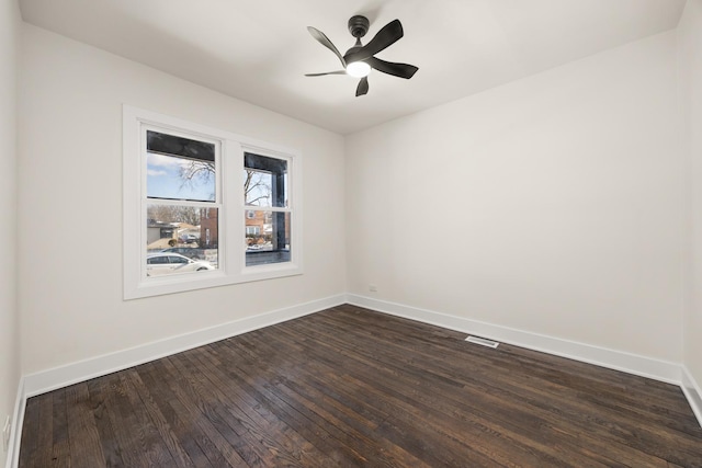 unfurnished room with ceiling fan and dark hardwood / wood-style flooring