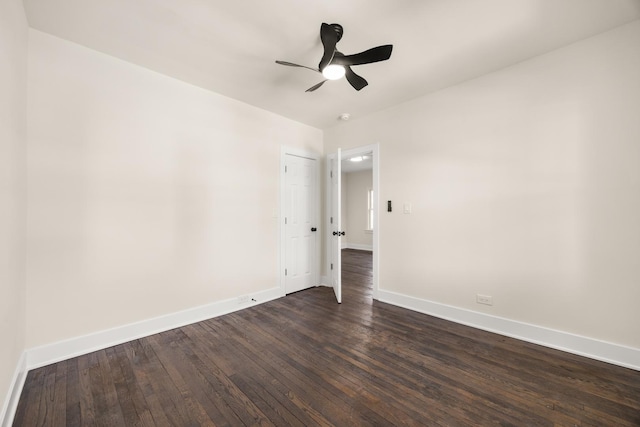 spare room with ceiling fan and dark hardwood / wood-style floors