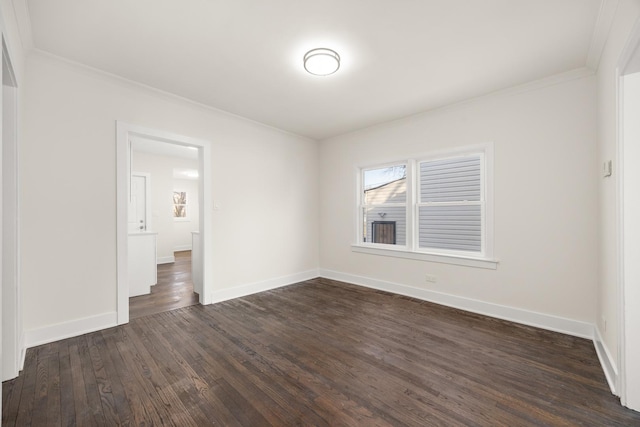 empty room featuring crown molding and dark hardwood / wood-style floors