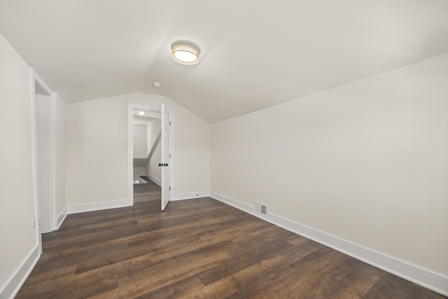 bonus room featuring vaulted ceiling and dark hardwood / wood-style floors