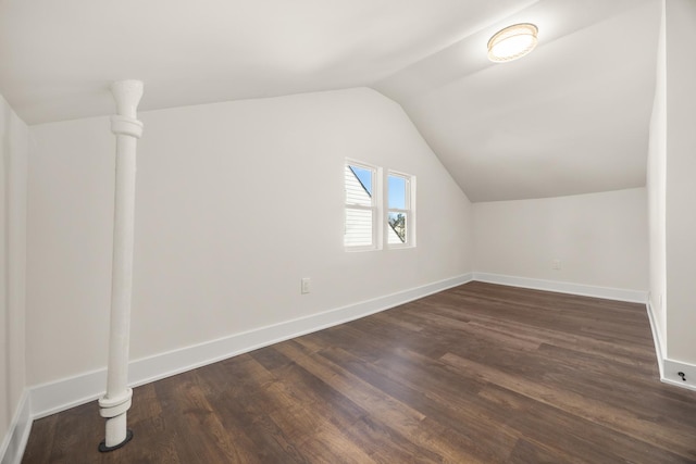 bonus room featuring vaulted ceiling and dark hardwood / wood-style floors