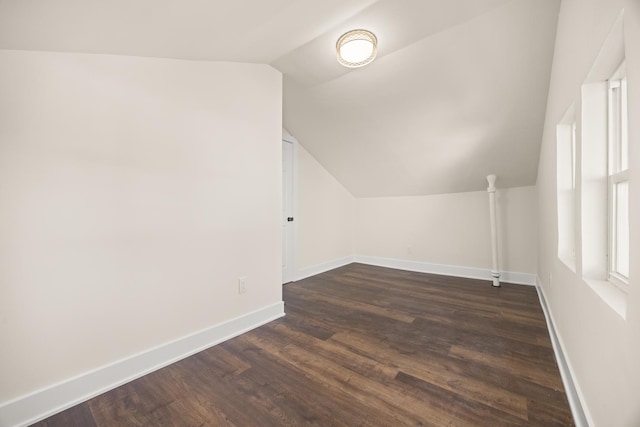 bonus room featuring vaulted ceiling and dark hardwood / wood-style floors