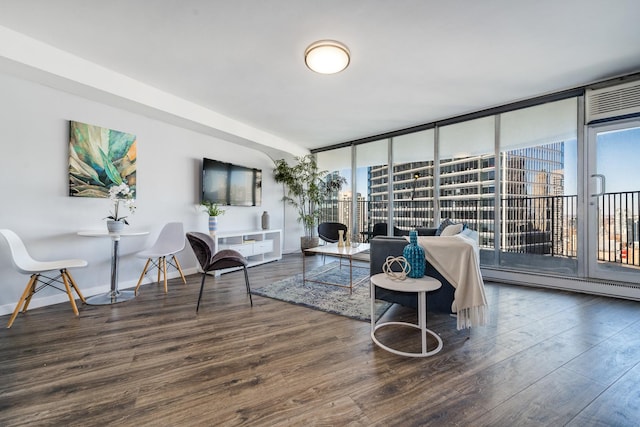 living room with dark hardwood / wood-style floors, floor to ceiling windows, and a baseboard heating unit