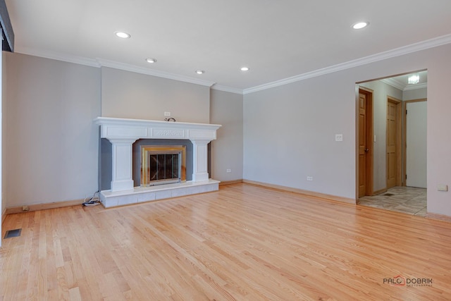 unfurnished living room with crown molding, a fireplace, and light hardwood / wood-style flooring