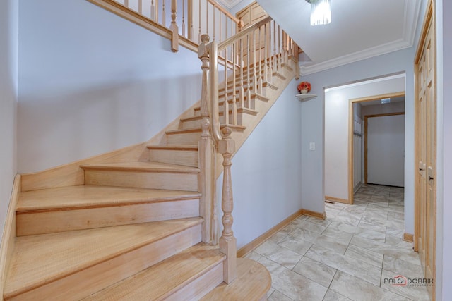 stairs featuring crown molding