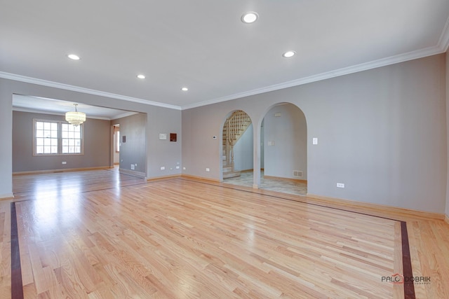 unfurnished room featuring crown molding and light hardwood / wood-style floors