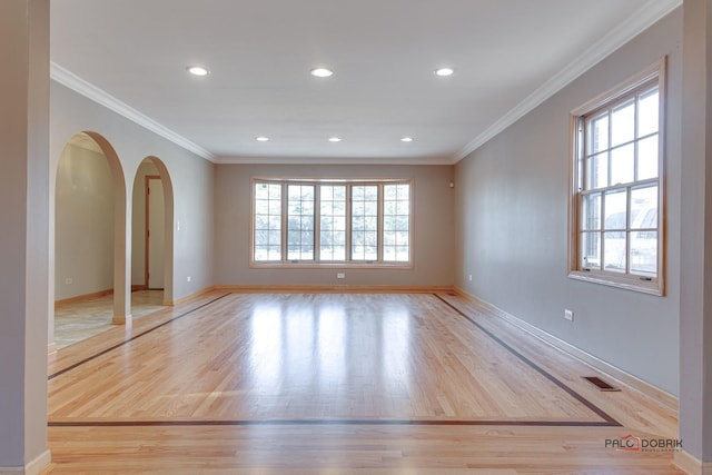 unfurnished room with ornamental molding and light hardwood / wood-style floors