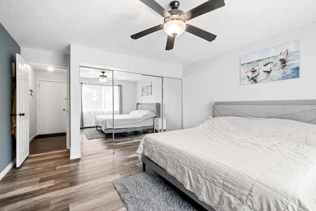 bedroom featuring wood-type flooring, a closet, and ceiling fan