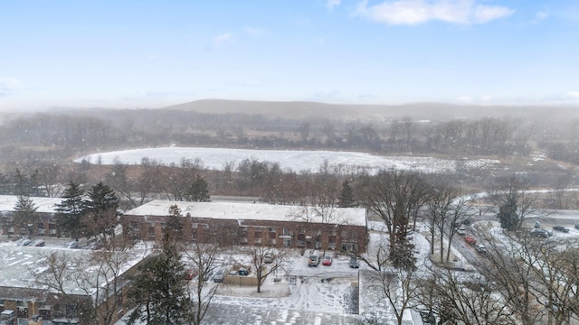 snowy aerial view featuring a mountain view