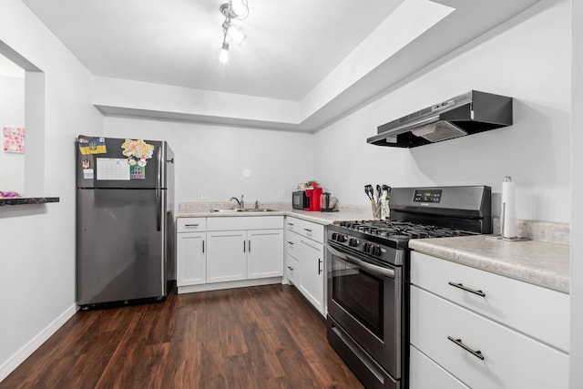 kitchen with sink, white cabinetry, stainless steel appliances, dark hardwood / wood-style floors, and extractor fan