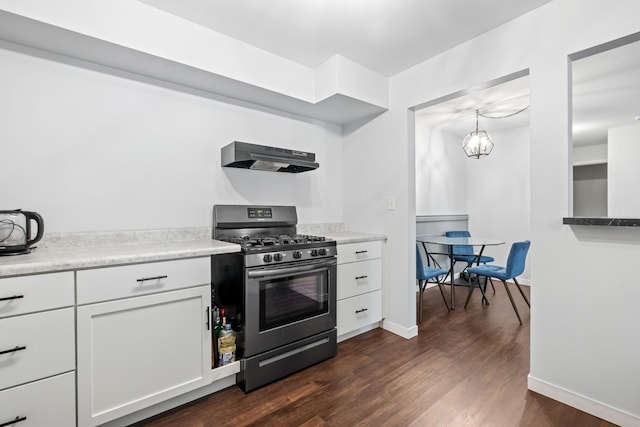 kitchen with range hood, white cabinetry, hanging light fixtures, dark wood-type flooring, and stainless steel range with gas stovetop