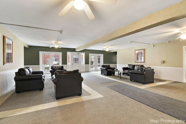 living room with light colored carpet, french doors, and ceiling fan