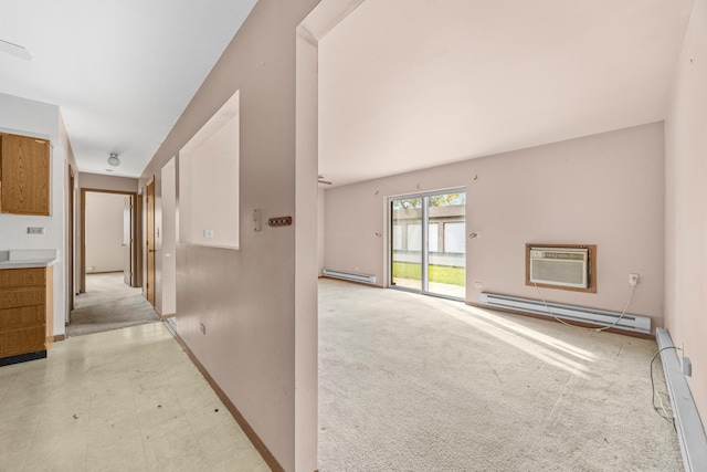 corridor featuring a wall mounted air conditioner, light colored carpet, and a baseboard heating unit