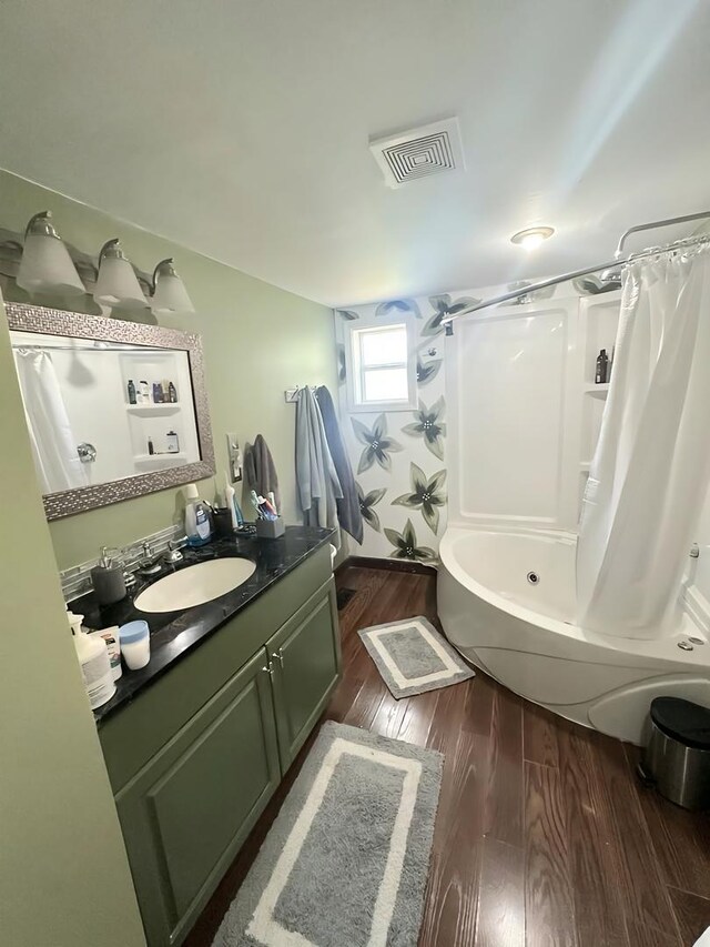110 S Cherry St, Somonauk, IL 60552 - full bathroom featuring wood finished floors, vanity, and shower / bath combo