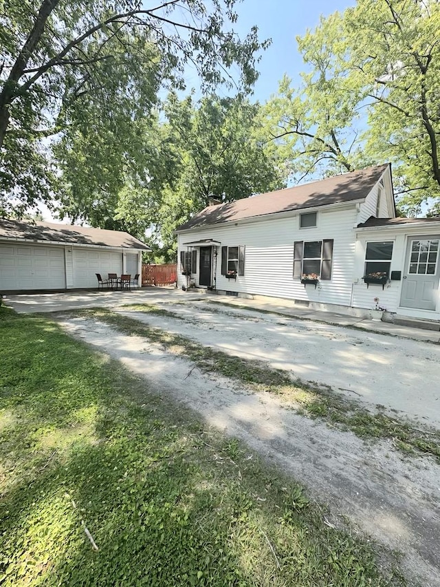 110 S Cherry St, Somonauk, IL 60552 - rear view of house with an outdoor structure and a chimney