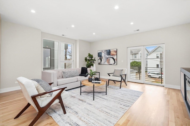 living room featuring light hardwood / wood-style floors and plenty of natural light