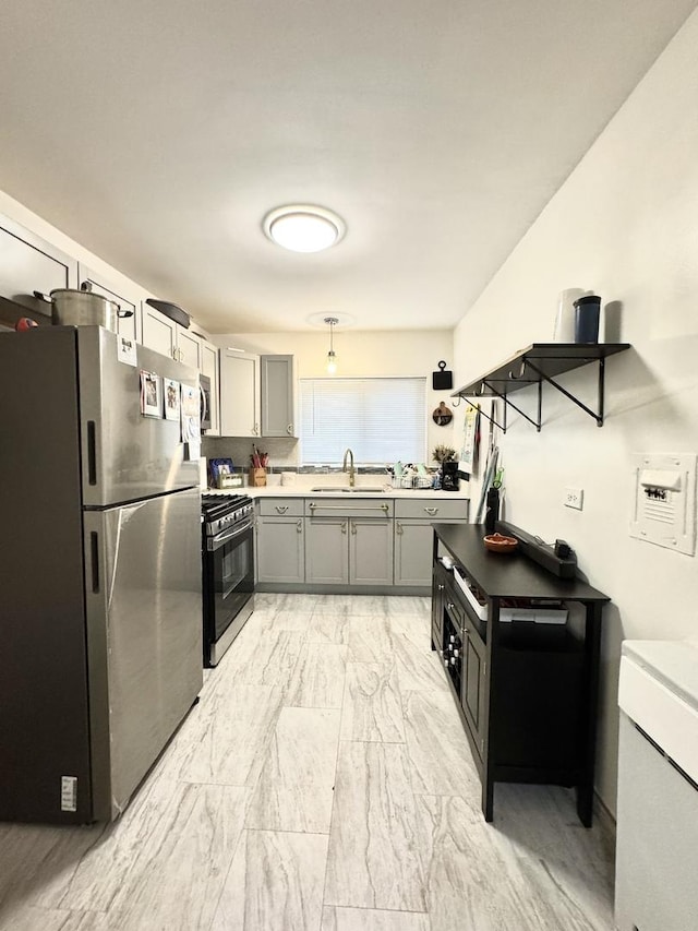 kitchen featuring sink, gray cabinets, and stainless steel appliances