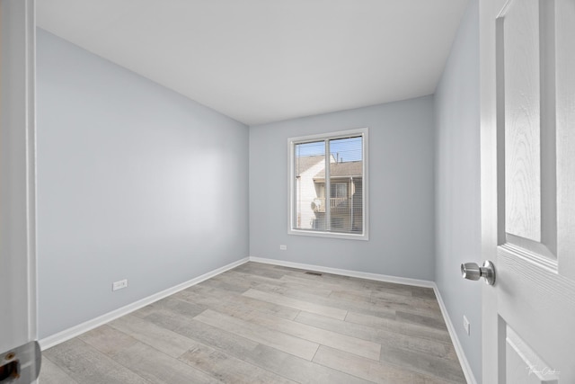 spare room featuring light hardwood / wood-style floors