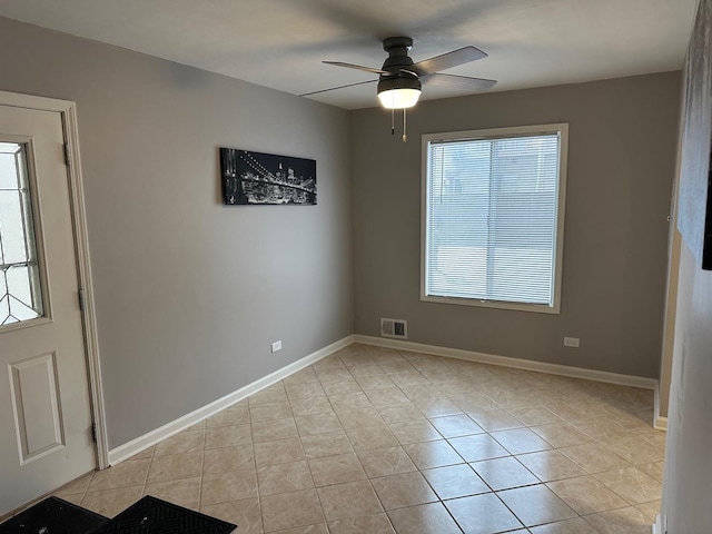 foyer with ceiling fan and light tile patterned flooring