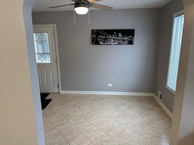 entryway featuring light tile patterned floors and ceiling fan