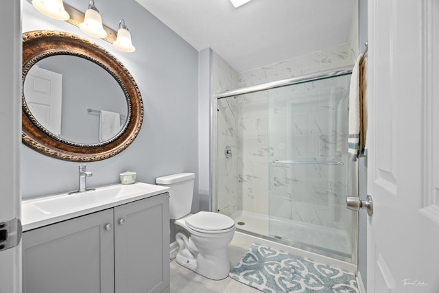 bathroom featuring vanity, toilet, and a shower with shower door